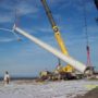 Cranes lifting wind turbine